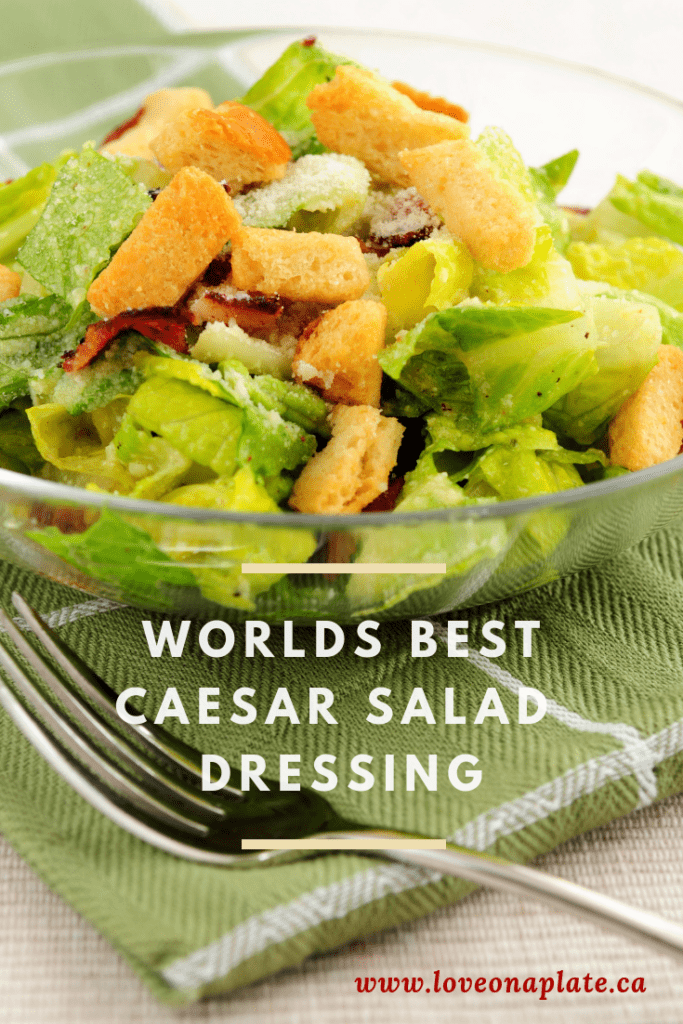 Caesar Salad with Bacon and Croutons in a glass bowl