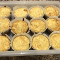 12 banana muffins in a tupperware storage container