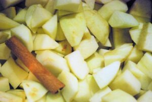 Close up of chopped apples and a cinnamon stick