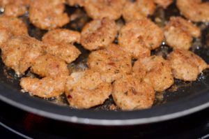 Fry breaded shrimp in pan