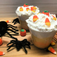 Candy Corn Parfaits, orange, white and yellow layers of pudding in a glass cup