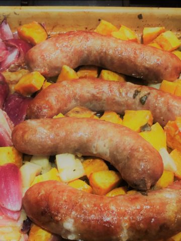 Sausage, Sweet Potato, Onions roasting on a sheet pan