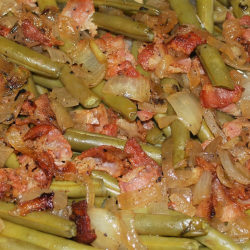 Cooked fresh green beans with bacon and onions