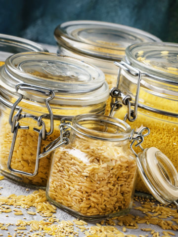 Assorted cereals and grains in glass jars for storage,