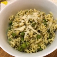 Garlic Parmesan Herbed Rice Pilaf in a white blow with shaved fresh parmesan on top