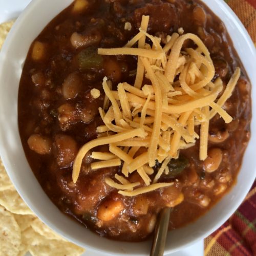 Close up of Taco Soup with shredded cheese on top.