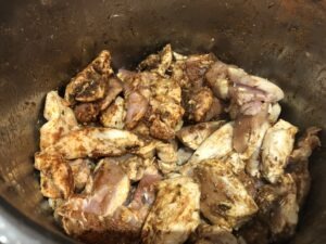 Sauteeing the marinated chicken and spices in an instant pot