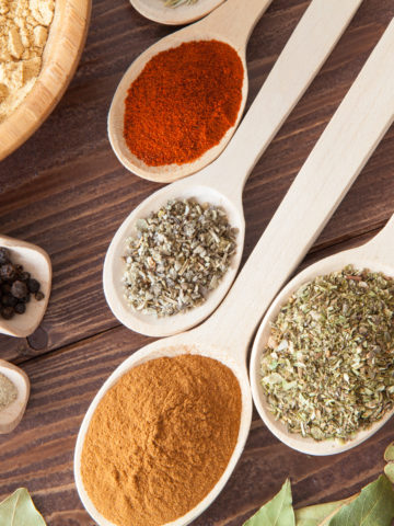 Assorted Herbs and Spices on wooden spoons