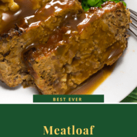 Sliced meatloaf with gravy, mashed potatoes and peas on a white plate.