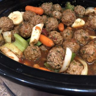 Meatball Stew; Meatballs, baby carrots, sliced celery, Sliced parsnips in sauce in the slow cooker