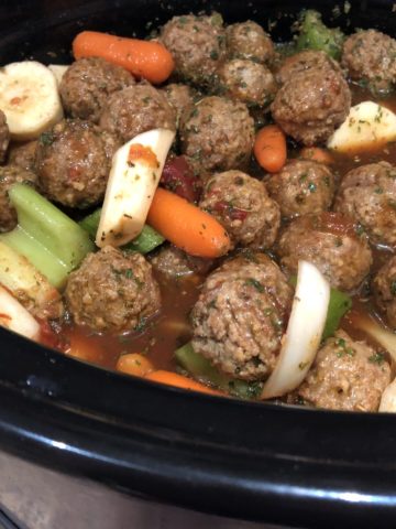 Meatball Stew; Meatballs, baby carrots, sliced celery, Sliced parsnips in sauce in the slow cooker