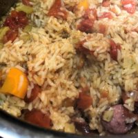 Cooked rice, celery and sausage close up.