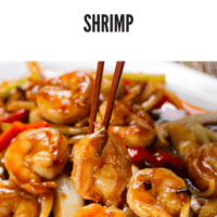 Shrimp, onions, peppers, dried chilies plated with chopsticks standing up