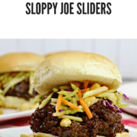 Thai seasoned ground beef on a toasted hamburger bun topped with broccoli slaw, on a white plate with peanuts scattered on it.