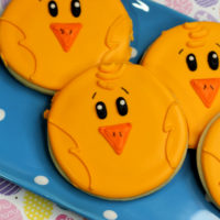Round Sugar Cookie Decorated with yellow royal icing to look like easter chicks