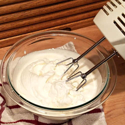 Glass bowl with a hand beater