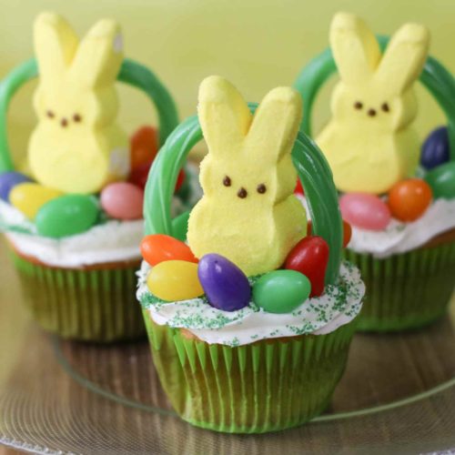 Yellow Peeps Bunny on top of cupcake with Jelly beans and a licorice used to make a basket handle