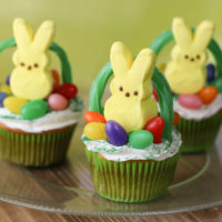 Yellow Peeps Bunny on top of cupcake with Jelly beans and a licorice used to make a basket handle