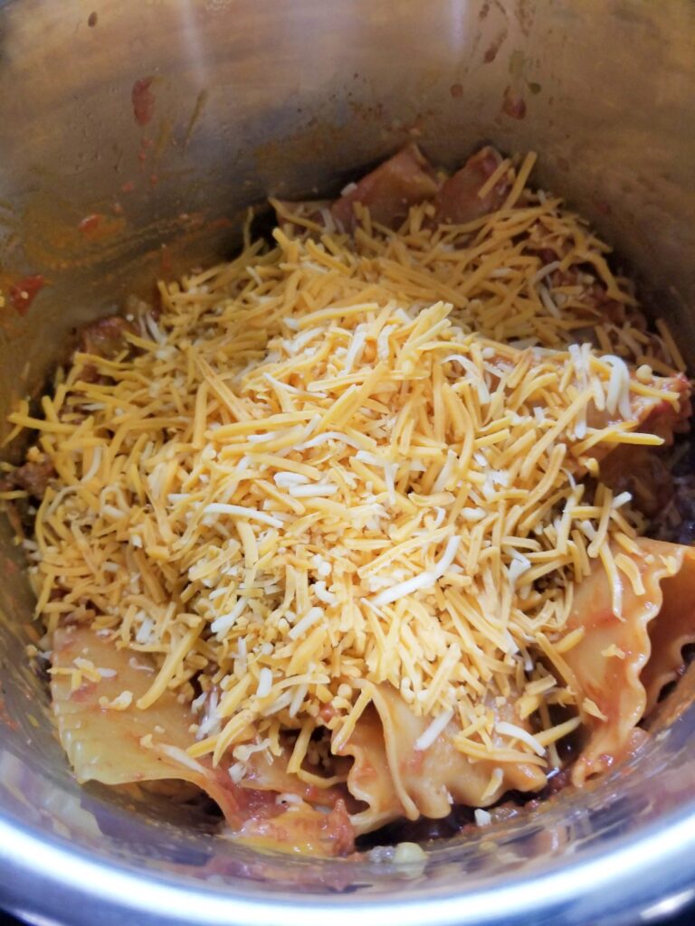 Shredded Tex Mex Cheese blend sprinkled on top of cooked noodle.