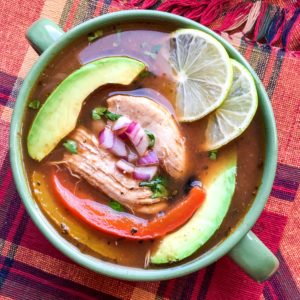 Slices of ripe avocado and melted shredded cheese top this delicious Chicken Fajita soup made in the Instant Pot in just 15 minutes