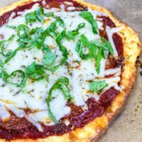 No Dough Pizza made from cream cheese and eggs. Add your favourite toppings for a keto pizza you will love