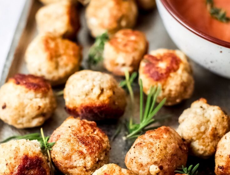 chicken meatballs on a platter with marinara dipping sauce