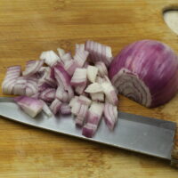 diced red onion on a wooden cutting board