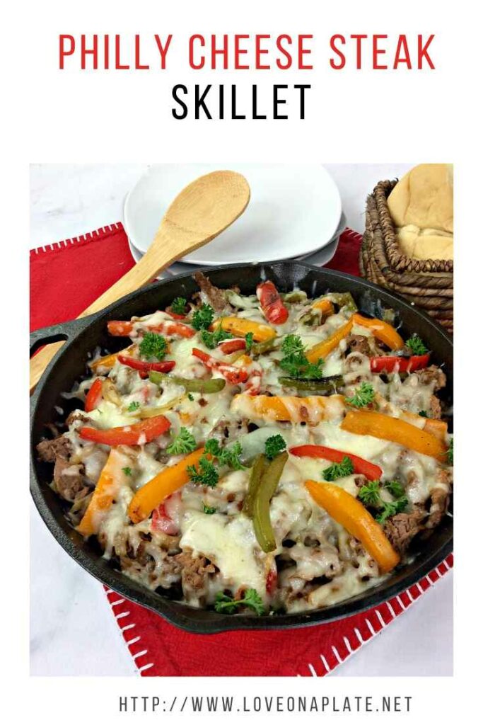 Philly Cheese Steak and peppers in a cast iron skillet