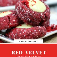 Red Velvet Thumbprint cookies rolled in sanding sugar and filled with cheesecake on a white cookie platter.