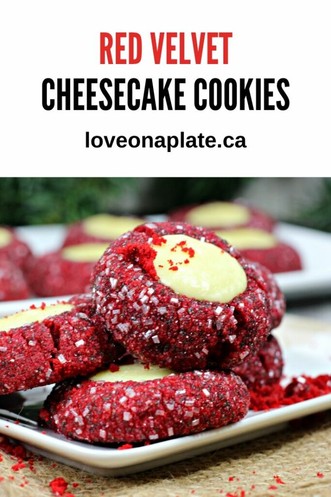 Red Velvet Thumbprint cookies rolled in sanding sugar and filled with cheesecake on a white cookie platter.