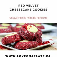 Red Velvet Thumbprint cookies rolled in sanding sugar and filled with cheesecake on a white cookie platter.