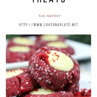 Red Velvet Thumbprint cookies rolled in sanding sugar and filled with cheesecake on a white cookie platter.