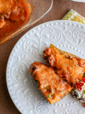 Ground Beef and Enchilada Sauce stuffed Zucchini with melted cheese