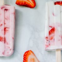 Greek Yogurt popsicles studded with fresh strawberry slices.