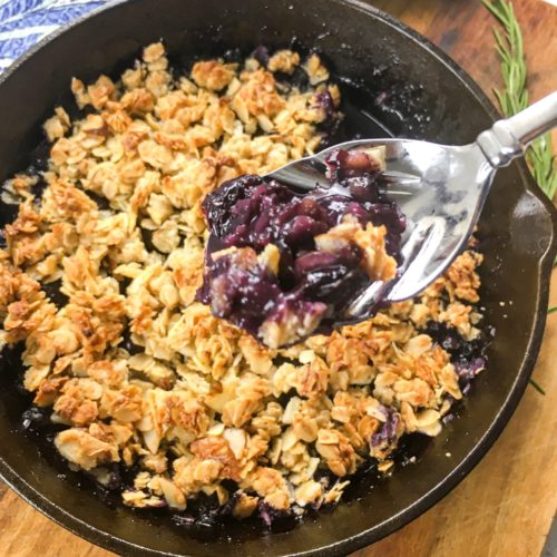 Oven baked skillet Gluten Free Blueberry crisp flavored with maple syrup.