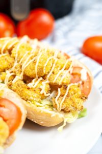 cornmeal crusted shrimp air fried, stacked on a hoagie bun with lettuce, tomato and mayonnaise